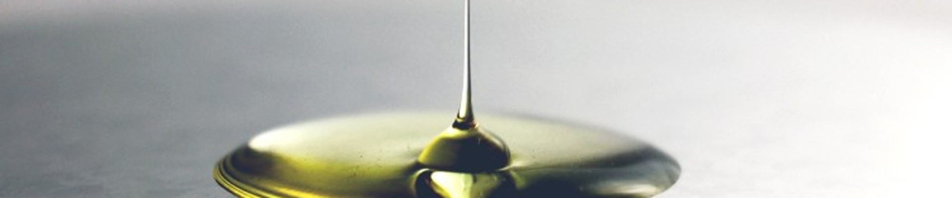 Gold-colored oil drop on black background 