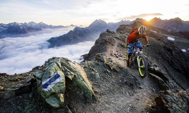 Mountain crest in the morning light with a mountain bike cyclist